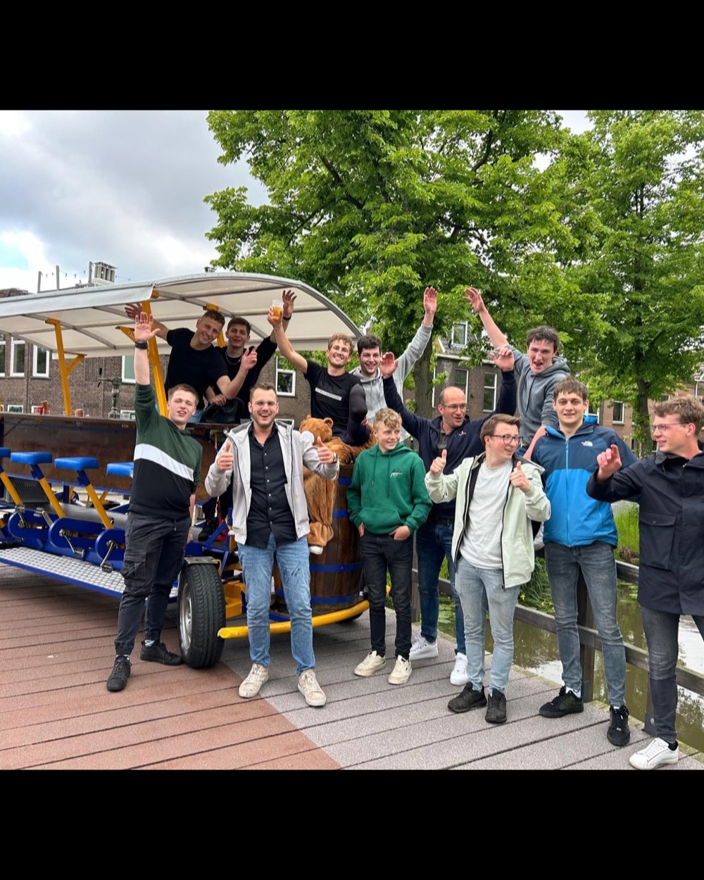 Group on a DamTours beer bike on an Amsterdam canal bridge
